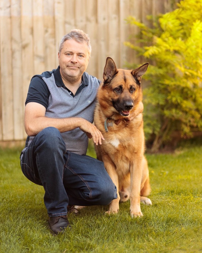 Steve Ryan in his garden with his German Shepherd, Coco